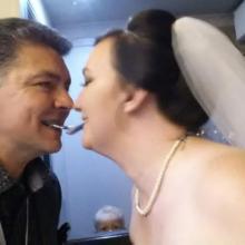 Darren Brand the wedding magician appears to be kissing this bride well in fact if you look close you will see they both have a card in their mouth and the cards are touching. At this moment the cards magically switch places so Darren has the brides card and the bride then has Darren‘s card in her mouth which always amazes the crowds.