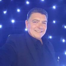 With light up stars in the background stands Darren Brand a Yorkshire magician.